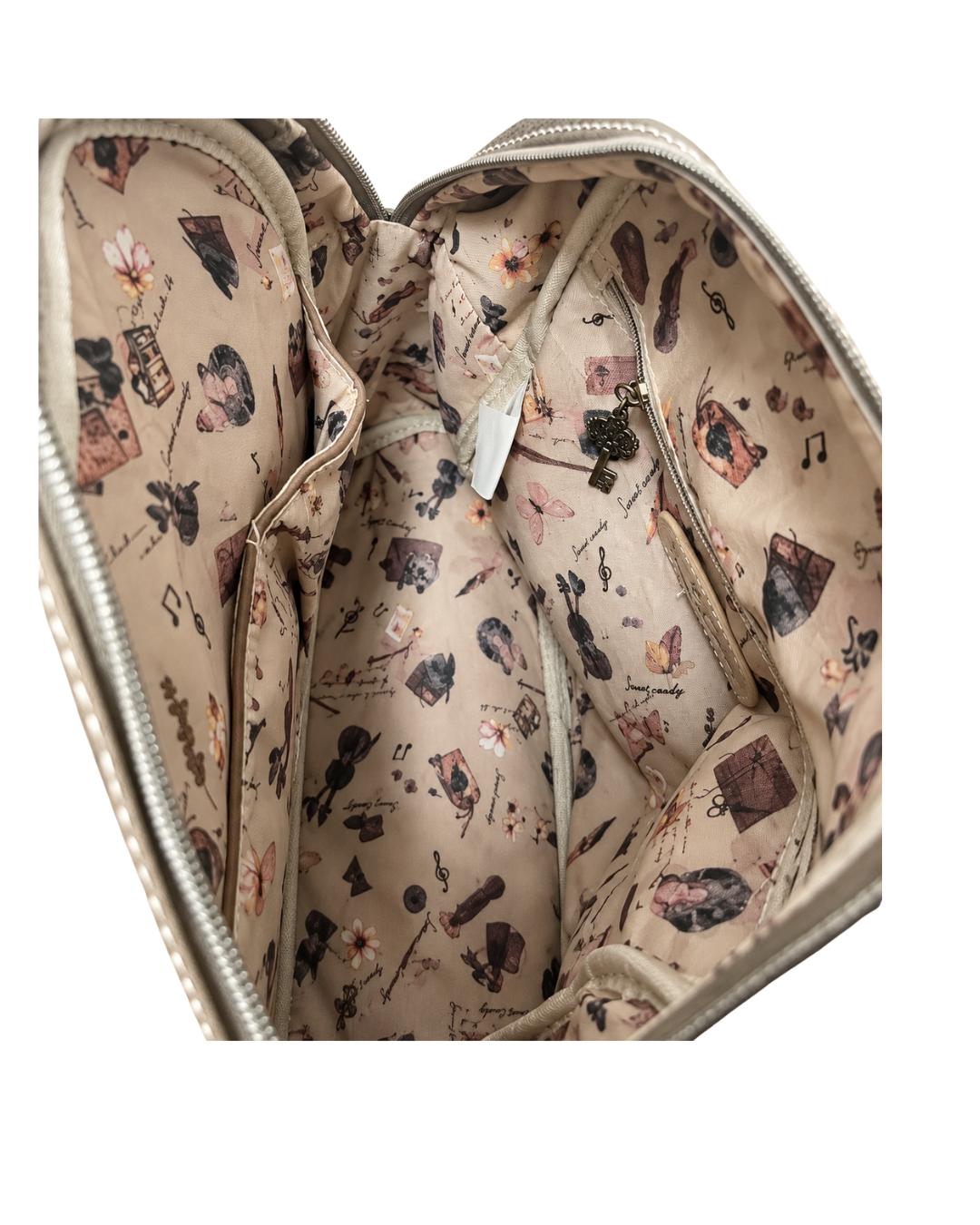 Interior de mochila Sweet Candy con forro beige estampado, bolsillos abiertos y bolsillo con cremallera.