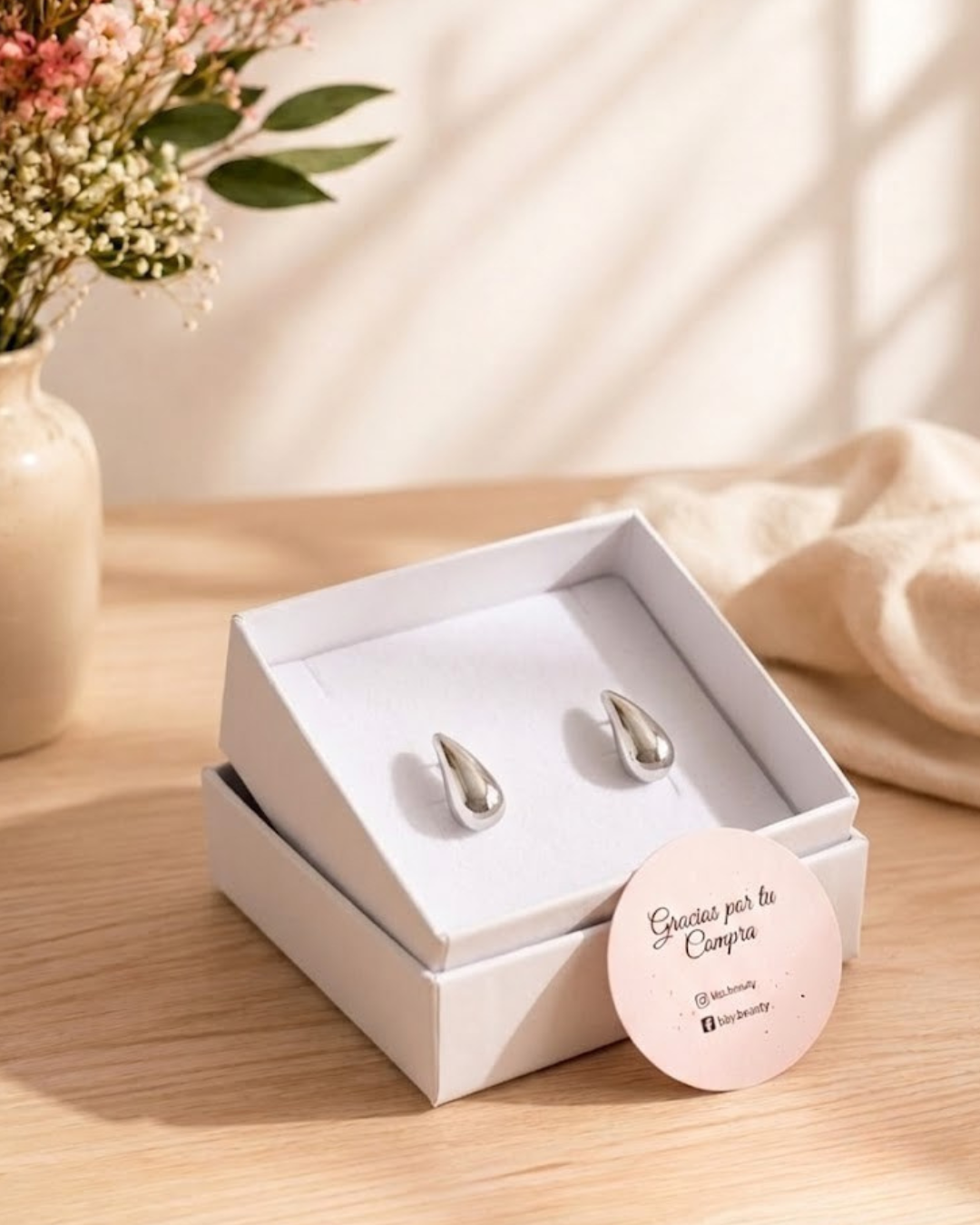 Pendiente pequeño de acero con forma de gota abombada pegado al lóbulo, de Accesoriomanía.